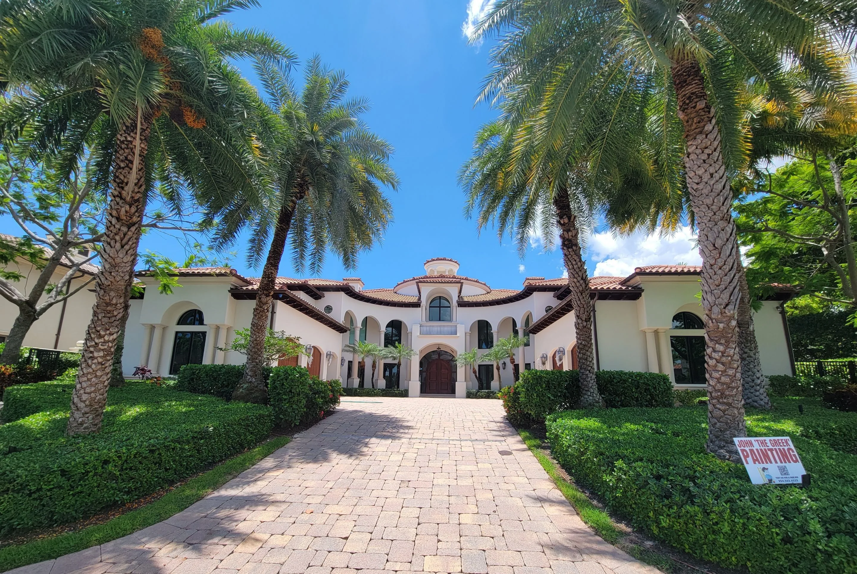 Freshly painted exterior of a South Florida home with palm trees
